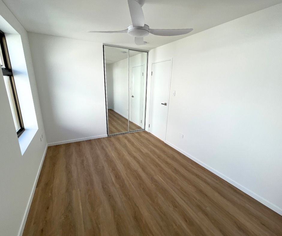 Empty, White-walled Room With Wood-look Flooring — Nyblad Construction in Maroochydore, QLD