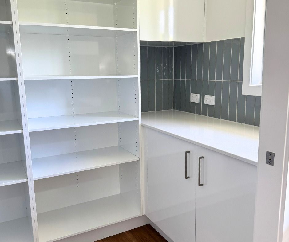 White Pantry With Shelves, Countertop, Cabinets and Grey Tiled Backsplash — Nyblad Construction in Buderim, QLD