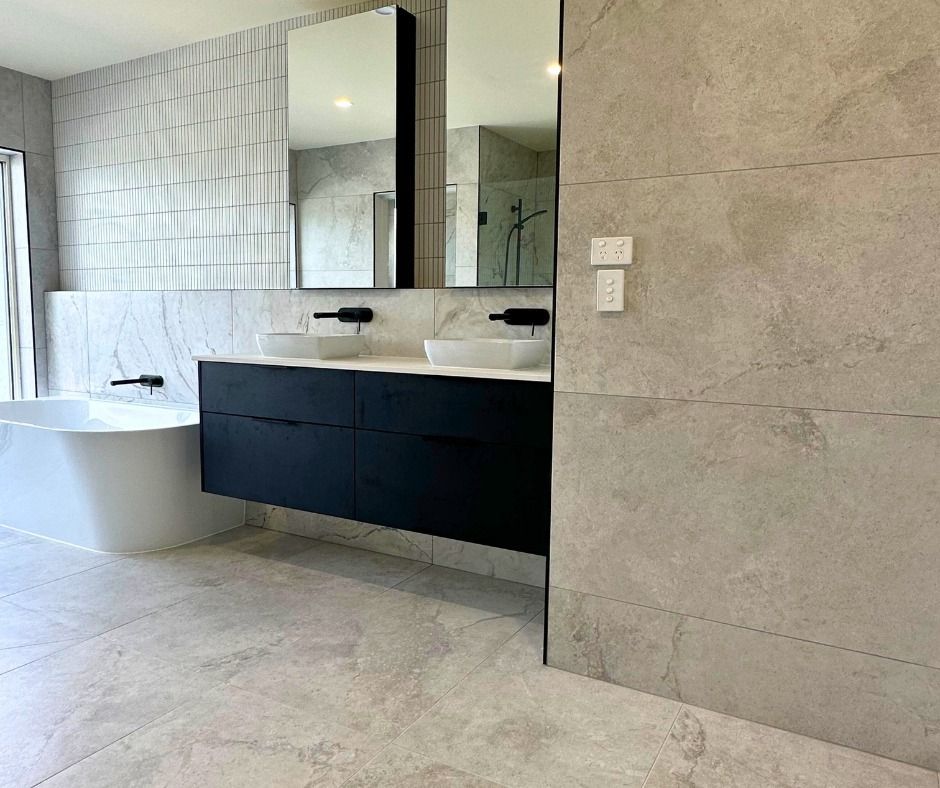 Modern Bathroom With a Floating Black Vanity, Two Mirrors — Nyblad Construction in Caloundra, QLD