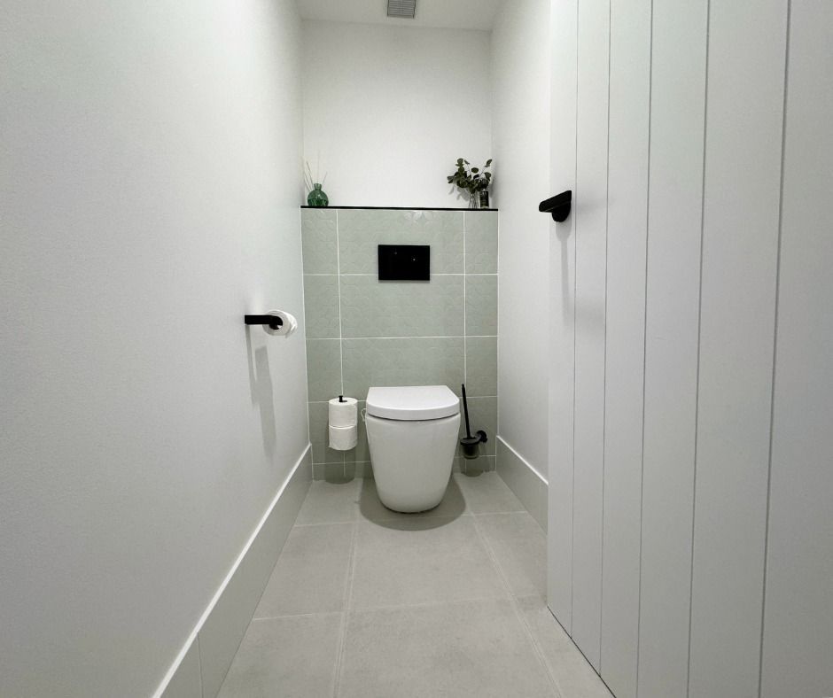 A Small, Modern Bathroom With a White Toilet — Nyblad Construction in Buderim, QLD