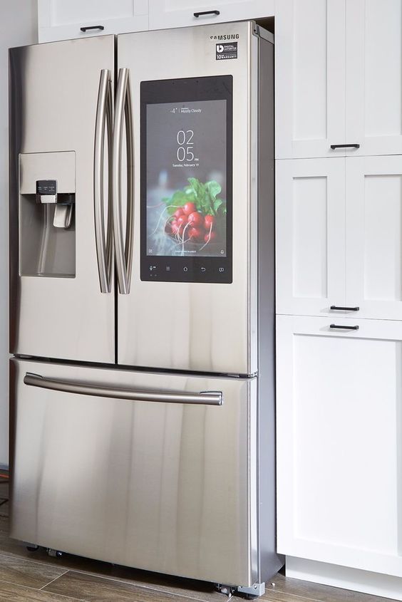 A Stainless Steel Refrigerator With A Screen On The Door In A Kitchen — Nyblad Construction in Caloundra West, QLD