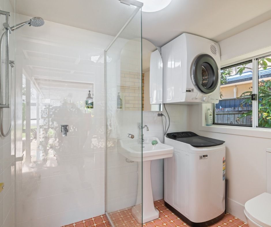 Small Bathroom With Shower, Sink, Toilet, and Stacked Washer — Nyblad Construction in Buderim, QLD