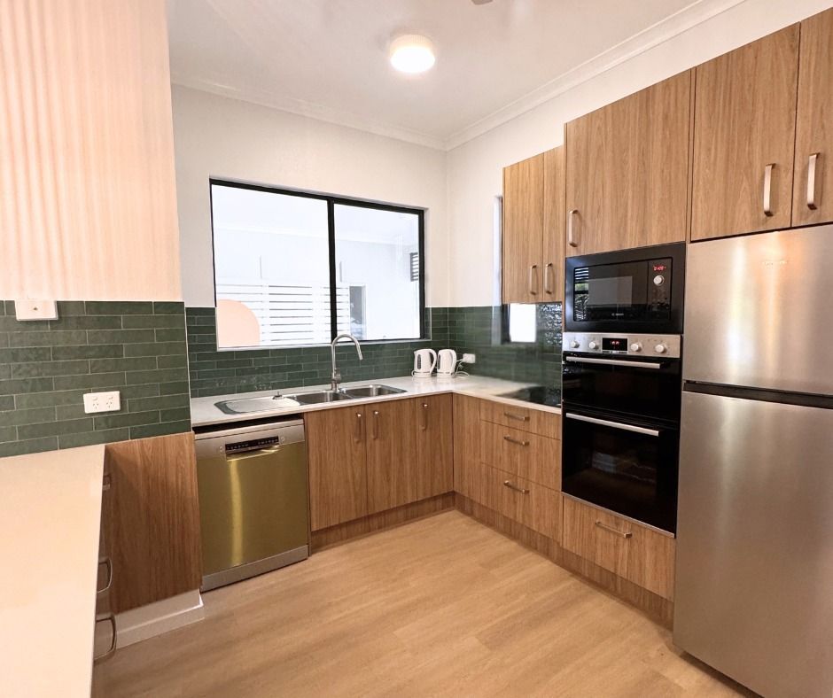 Modern Kitchen With Wooden Cabinets, Stainless Steel Appliances, and Green Tile Backsplash — Nyblad Construction in Maroochydore, QLD