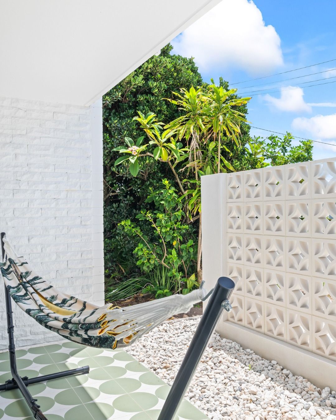 Hammock Hangs on a Patio, Framed by White Brick and a Patterned Wall — Nyblad Construction in Caloundra, QLD
