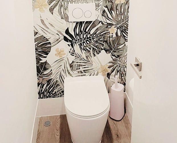 Toilet in a Bathroom With a Floral Wallpaper — Nyblad Construction in Caloundra West, QLD