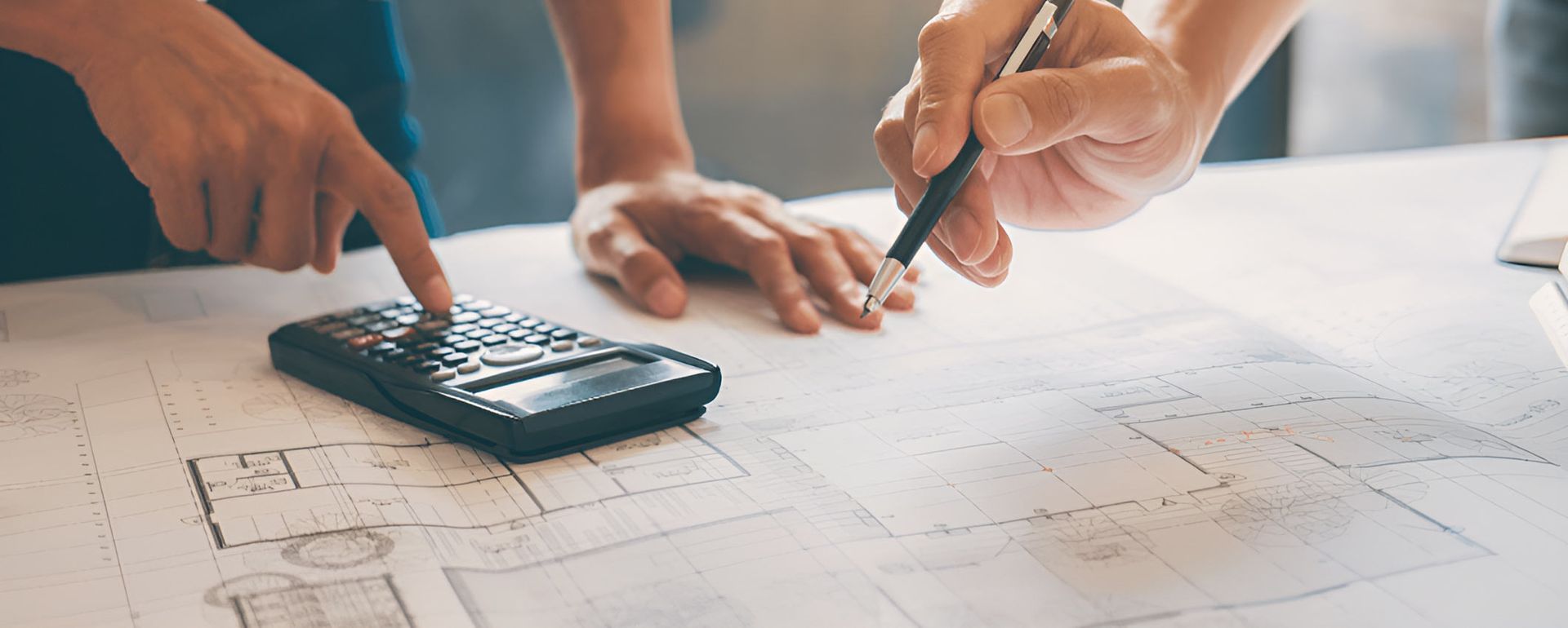 Looking At A Blueprint And Using A Calculator  — Nyblad Construction in Caloundra West, QLD