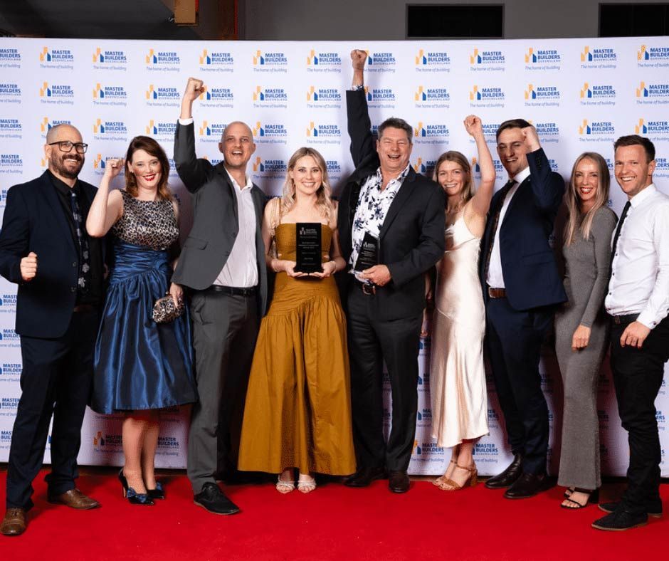 A Group Of People Are Posing For A Picture On A Red Carpet — Nyblad Construction in Caloundra West, QLD