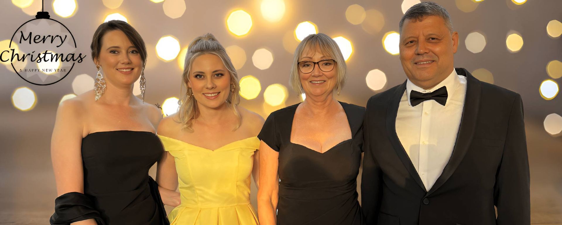 Family Is Posing For A Picture In Front Of A Christmas  — Nyblad Construction in Caloundra West, QLD