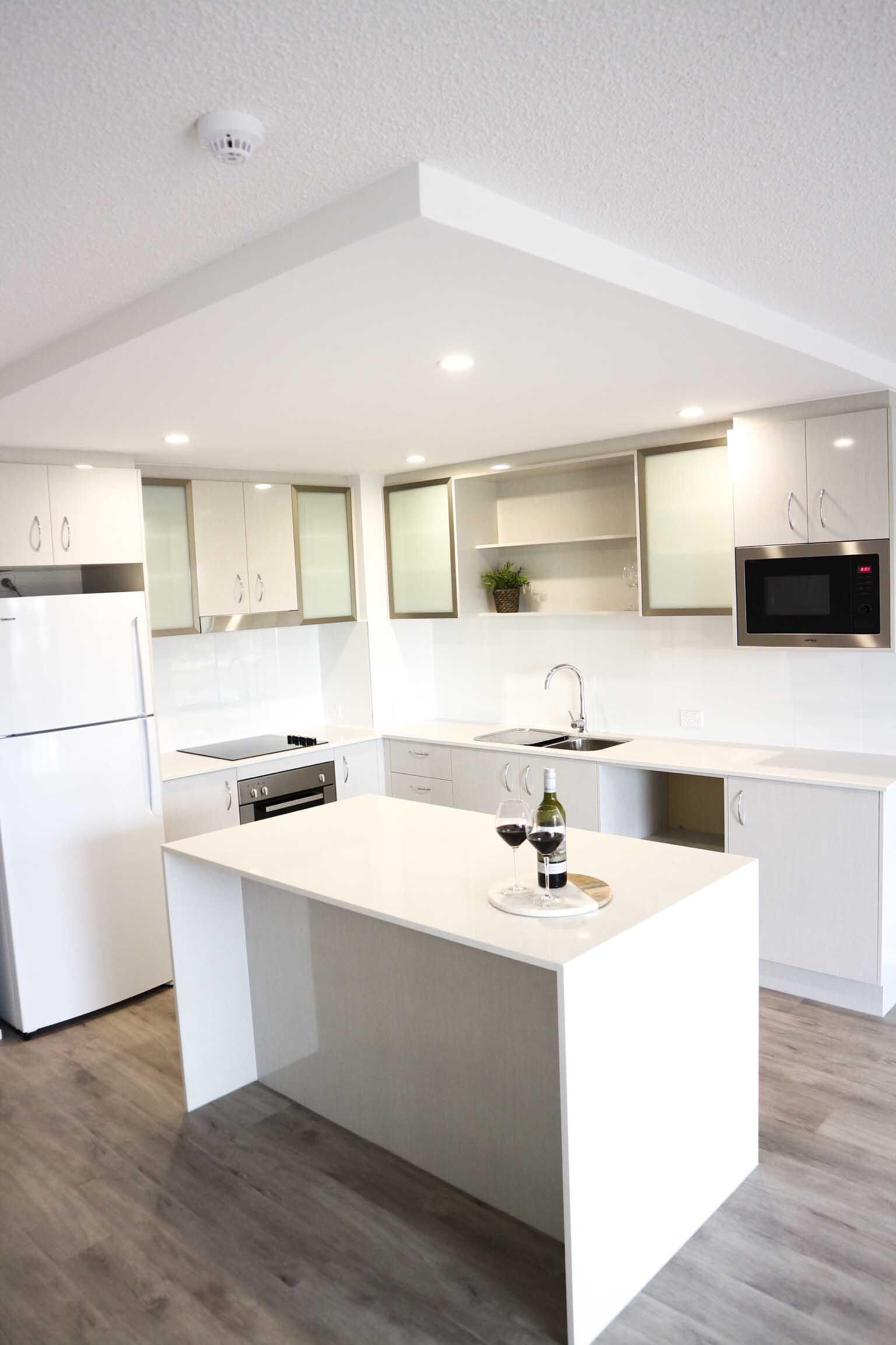 Kitchen With White Cabinets and a Large Island in the Middle — Nyblad Construction in Caloundra West, QLD