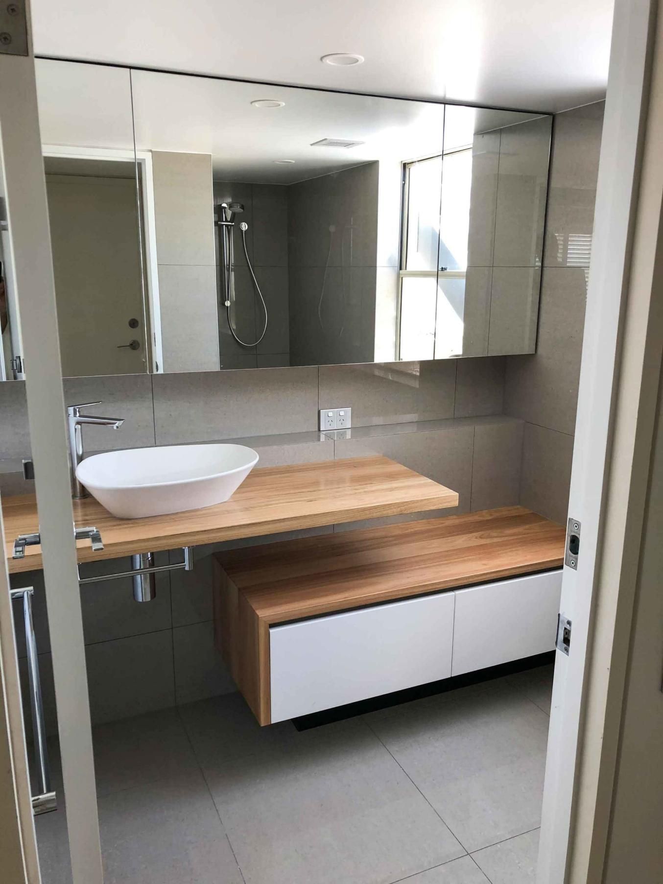 Bathroom With a Sink, Mirror and Shower — Nyblad Construction in Caloundra West, QLD