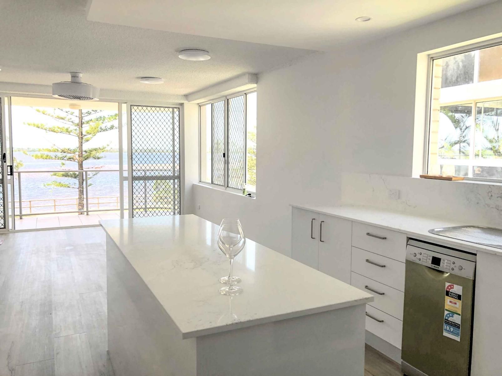 Kitchen With White Cabinets, a Large Island — Nyblad Construction in Caloundra West, QLD