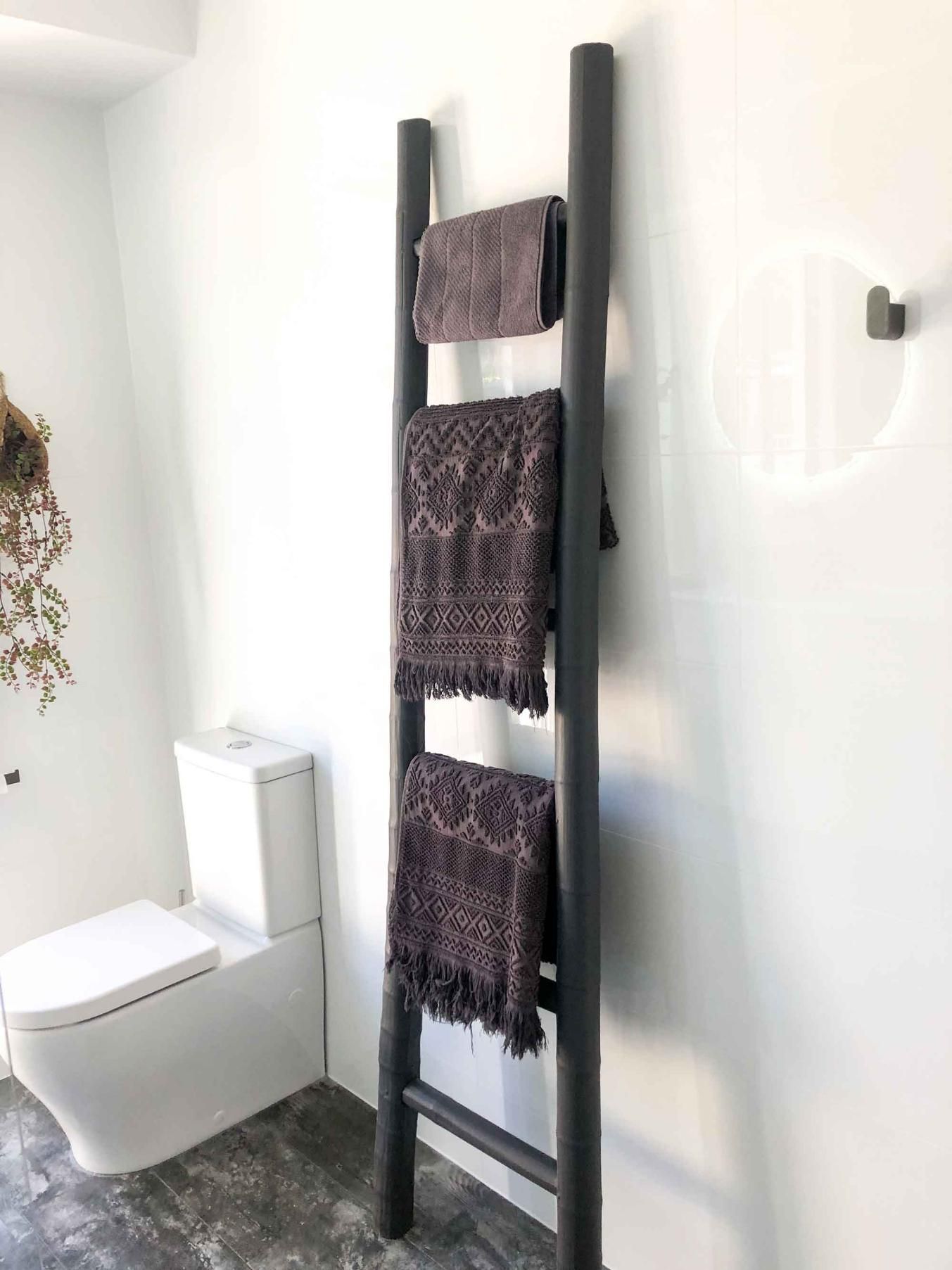 Bathroom With a Toilet and a Ladder With Towels on It — Nyblad Construction in Caloundra West, QLD