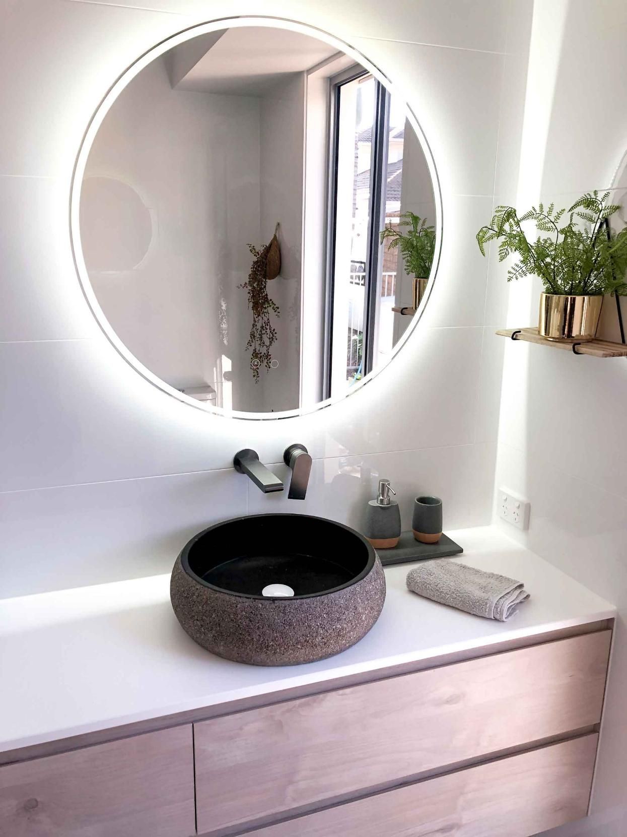 Bathroom With a Round Mirror and a Sink — Nyblad Construction in Caloundra West, QLD