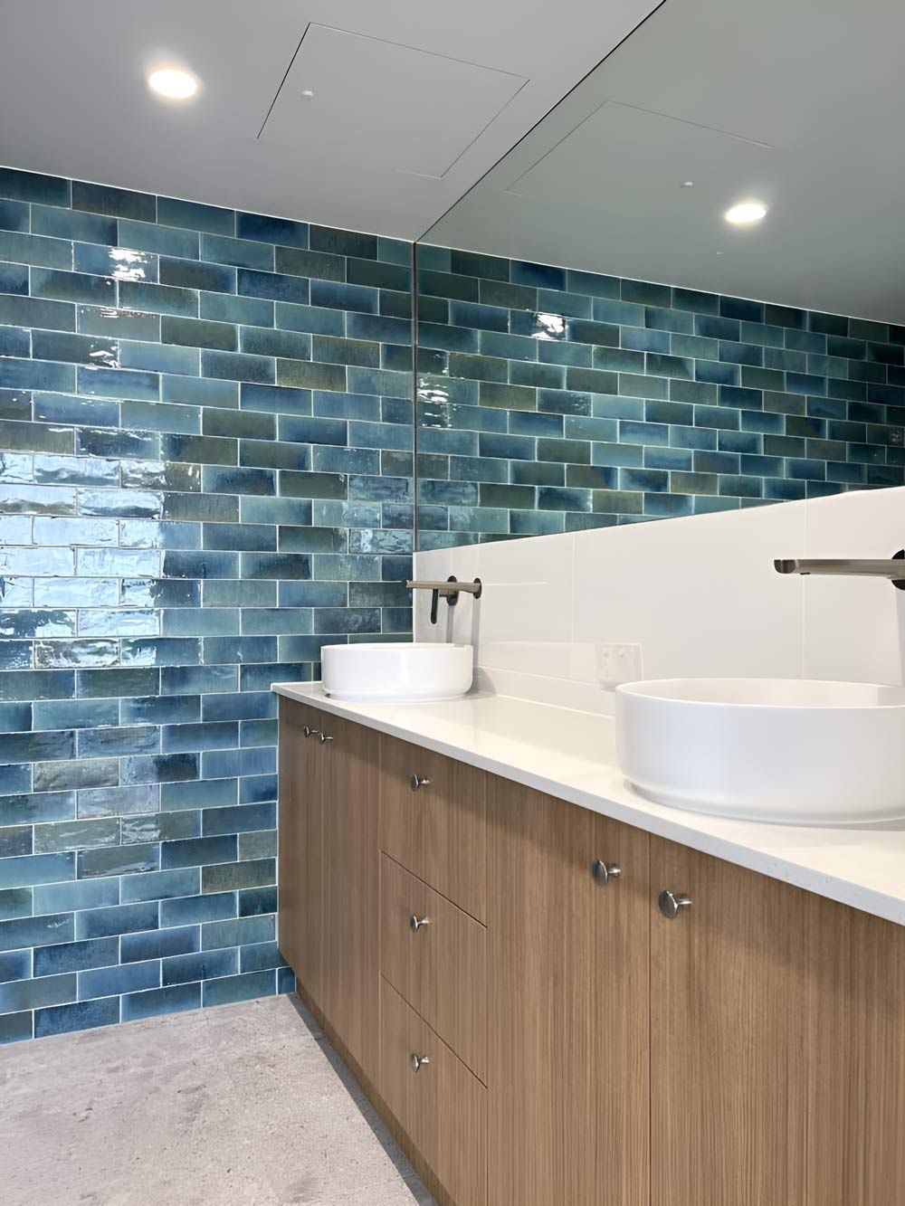 A Bathroom With Green Tiles — Nyblad Construction in Caloundra West, QLD