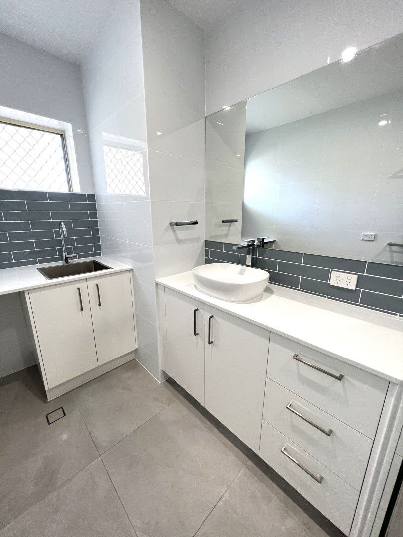 Modern bathroom with white cabinets, gray tile, and a vessel sink. — Nyblad Construction in Maroochydore, QLD