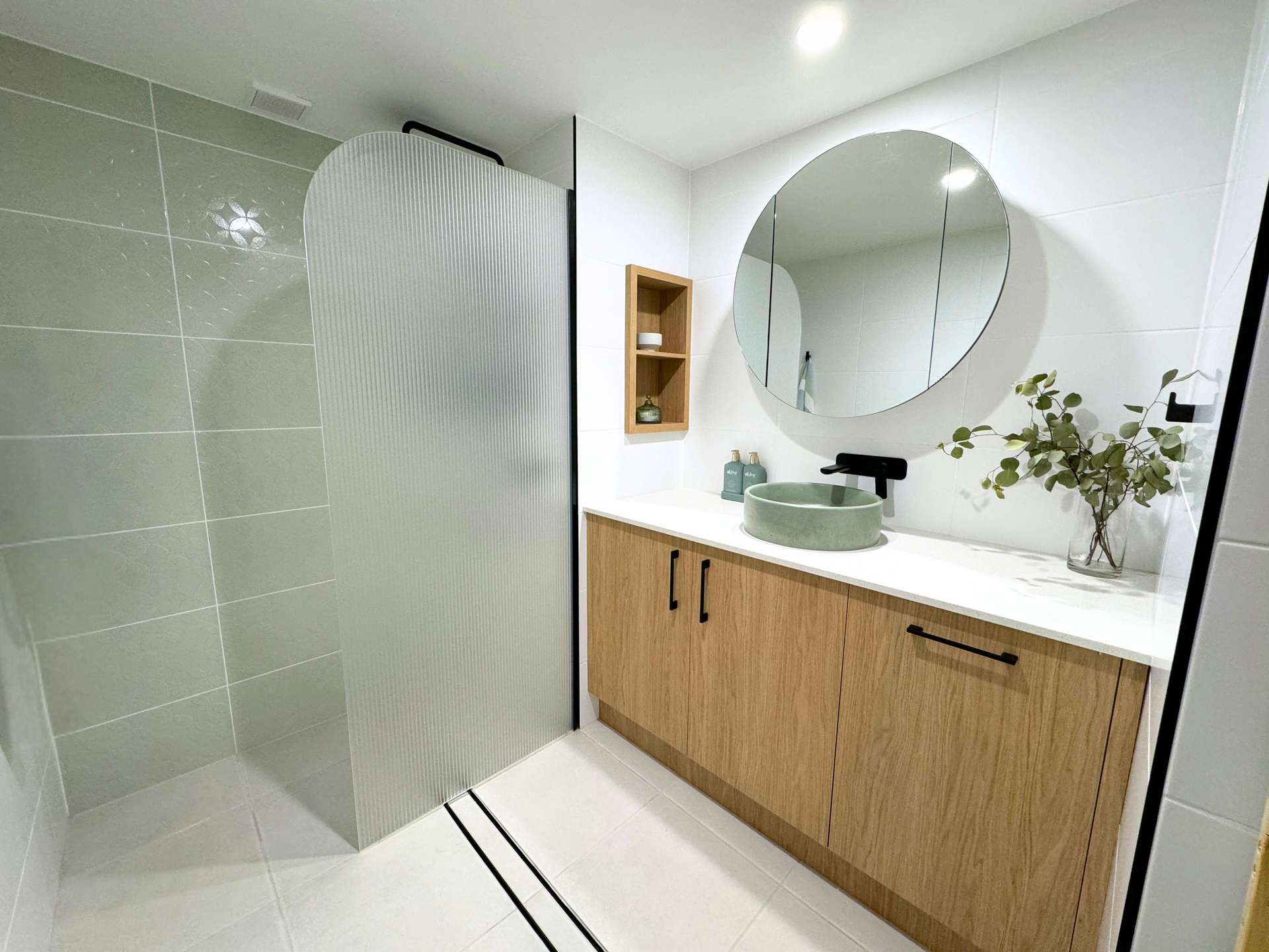 Bathroom With a Sink, Mirror, and Shower — Nyblad Construction in Caloundra West, QLD