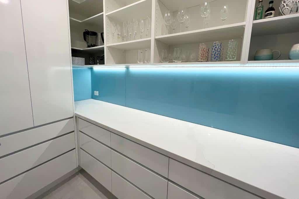 Kitchen With White Cabinets and a Blue Counter Top — Nyblad Construction in Caloundra West, QLD