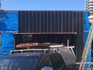 A Black Truck Is Parked In Front Of A Building Under Construction — Nyblad Construction in Caloundra West, QLD