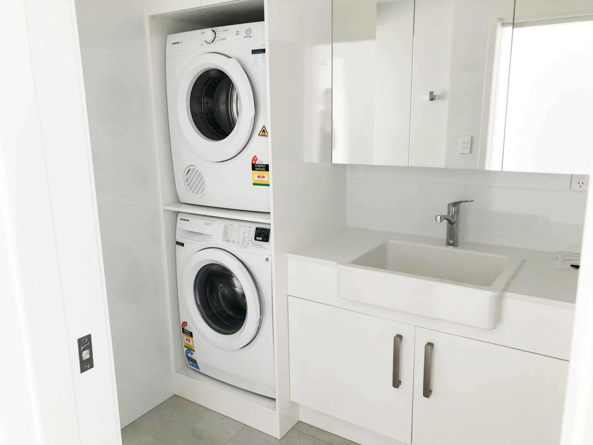 Laundry Room With a Washer and Dryer Stacked — Nyblad Construction in Caloundra West, QLD