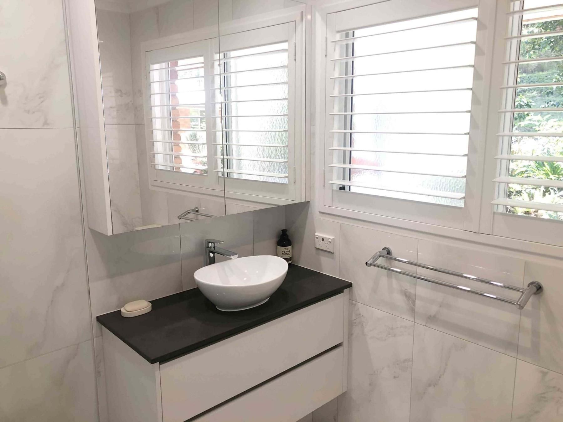 Bathroom With a Sink, Mirror and Shutters — Nyblad Construction in Caloundra West, QLD