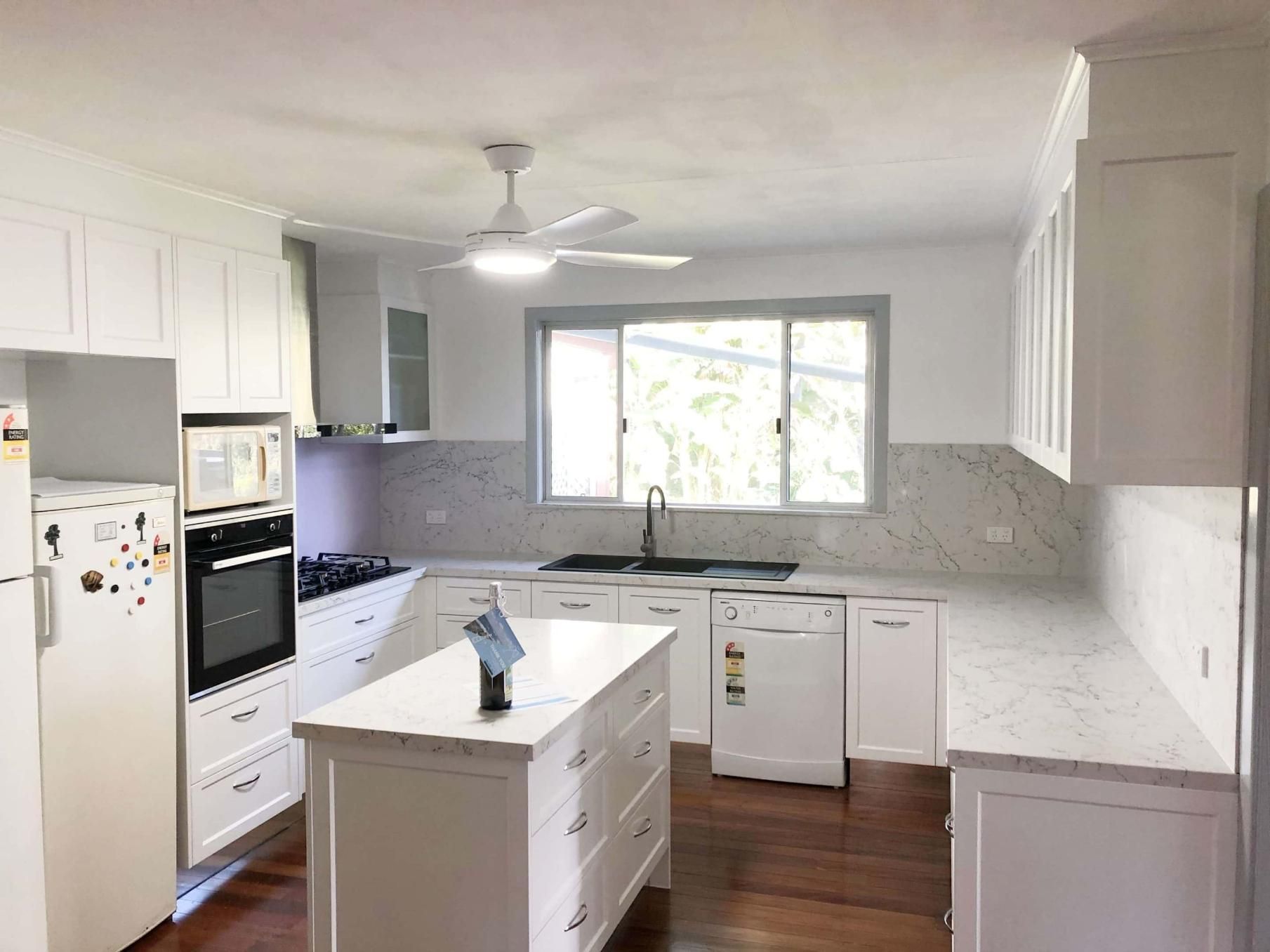 Kitchen With White Cabinets and a Large Island — Nyblad Construction in Caloundra West, QLD