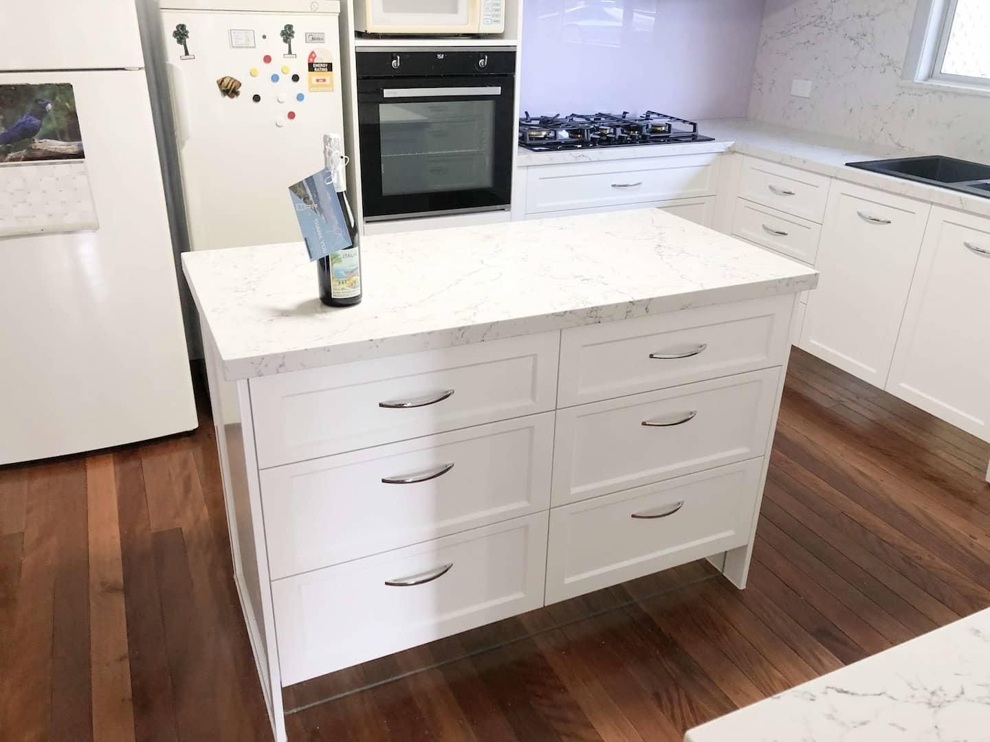 Kitchen With White Cabinets and a Large Island — Nyblad Construction in Caloundra West, QLD