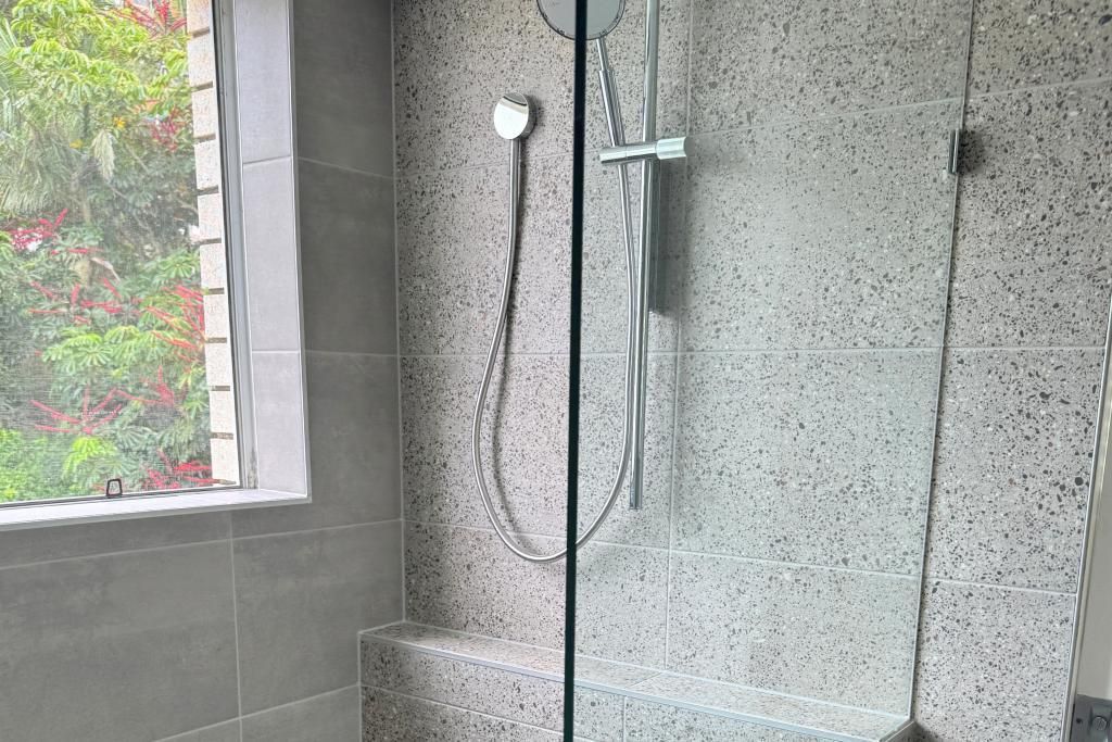 Bathroom With a Walk in Shower and a Window — Nyblad Construction in Caloundra West, QLD