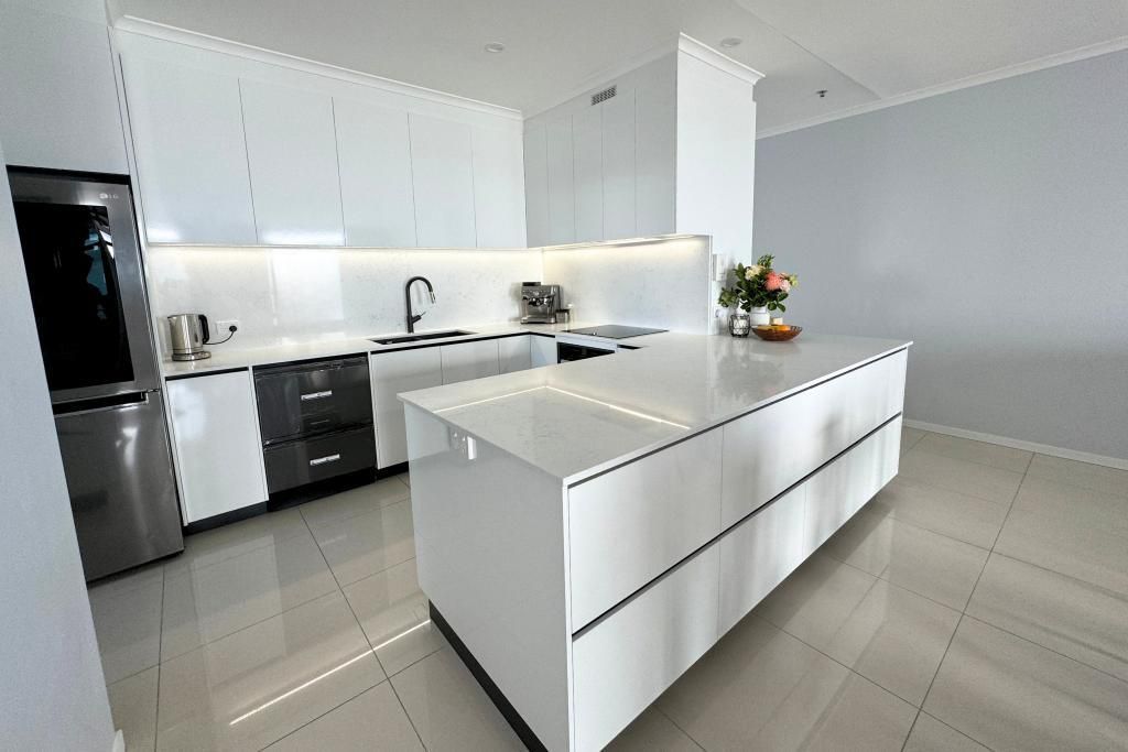 Kitchen With White Cabinets and a Large Island — Nyblad Construction in Caloundra West, QLD