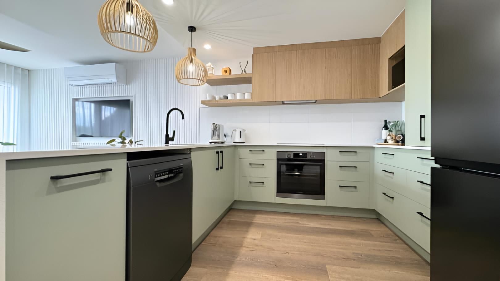 Kitchen With White Cabinets and Wooden Floors — Nyblad Construction in Caloundra West, QLD