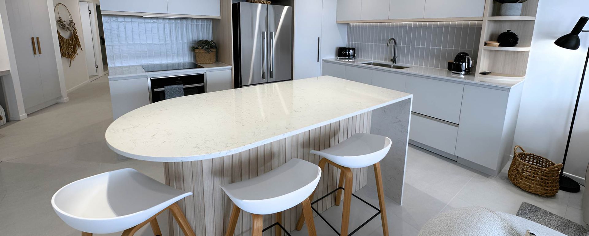 A Spacious Kitchen With A Big Island And Stools — Nyblad Construction in Caloundra West, QLD