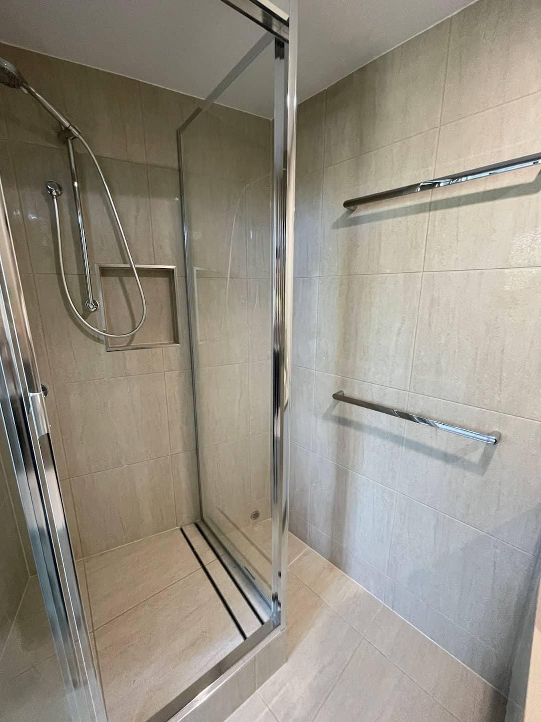 Bathroom With a Walk in Shower and a Towel Rack — Nyblad Construction in Caloundra West, QLD