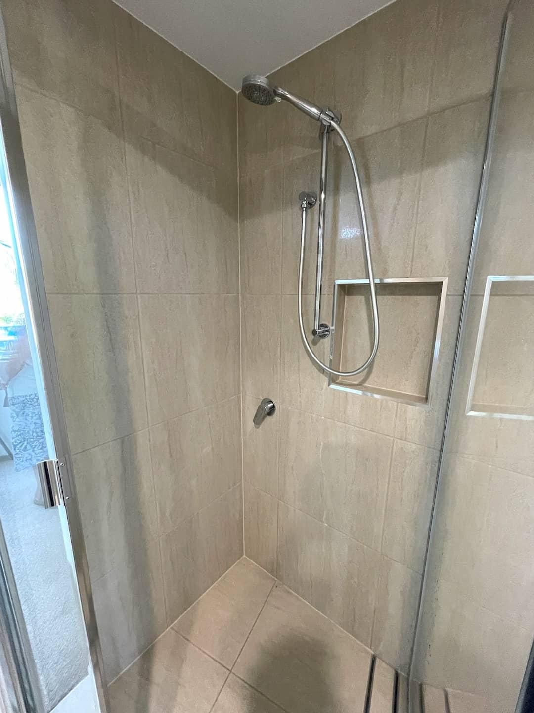 Bathroom With a Walk in Shower and a Glass Door — Nyblad Construction in Caloundra West, QLD