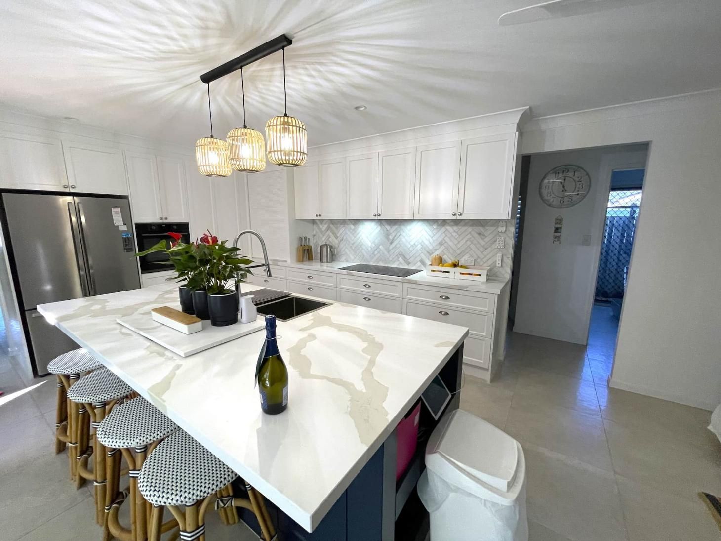 Kitchen With a Large Island and Stools — Nyblad Construction in Caloundra West, QLD