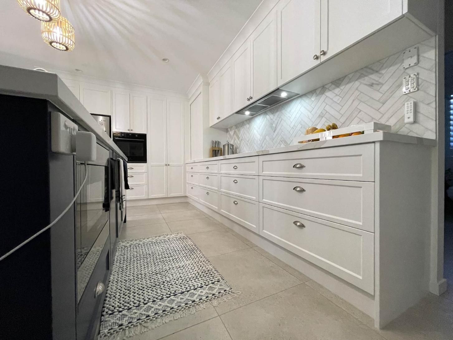 Kitchen With White Cabinets and a Rug on the Floor — Nyblad Construction in Caloundra West, QLD