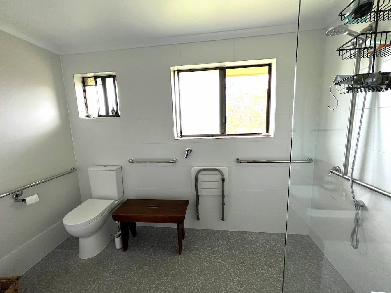 Bathroom With a Toilet a Bench and a Window — Nyblad Construction in Caloundra West, QLD