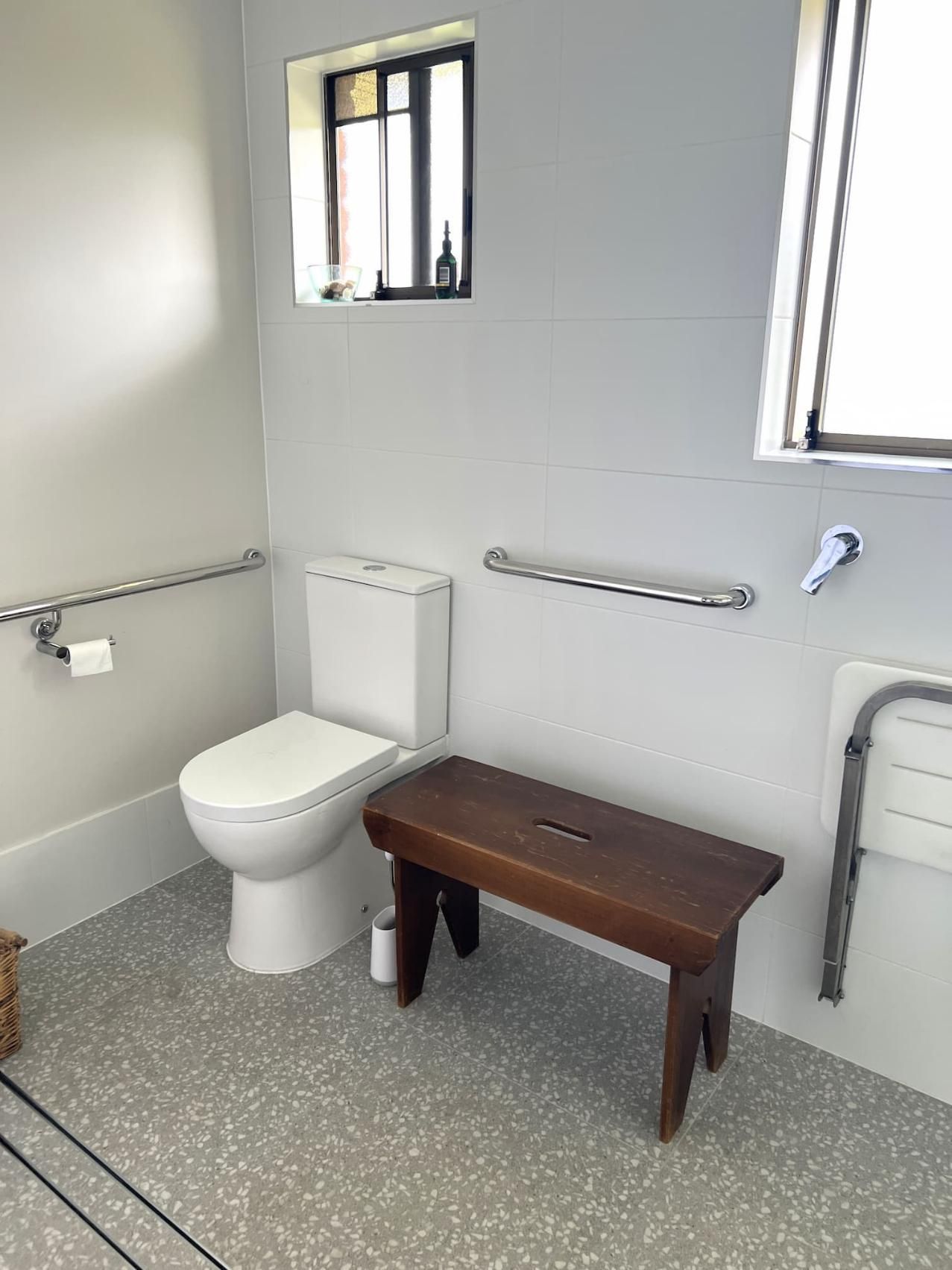 Bathroom With a Toilet and a Wooden Bench — Nyblad Construction in Caloundra West, QLD
