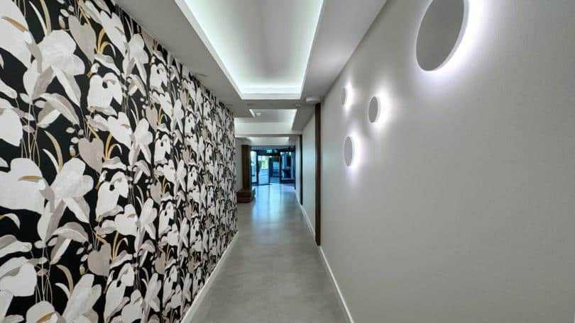 Long Hallway With a Floral Wallpaper on the Wall — Nyblad Construction in Caloundra West, QLD
