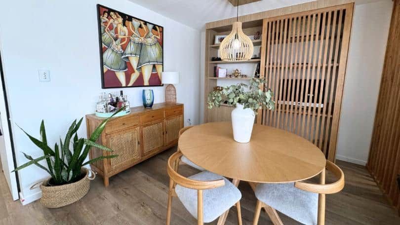 Dining Room With a Round Wooden Table and Chairs — Nyblad Construction in Caloundra West, QLD