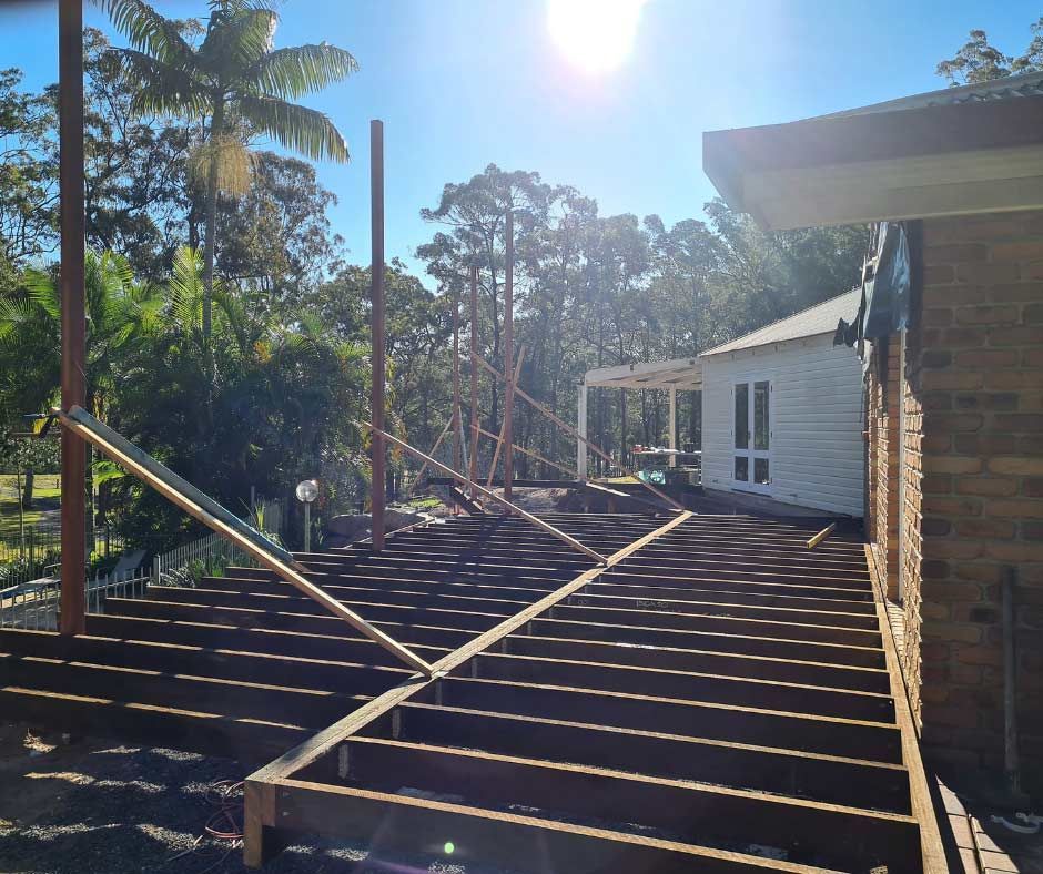 A House Is Getting A Wooden Deck Built In Its Front Yard — Nyblad Construction in Caloundra West, QLD