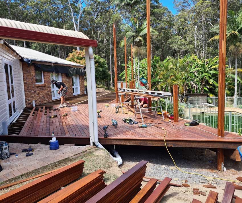 A Wooden Deck Is Being Built In Front Of A House — Nyblad Construction in Caloundra West, QLD