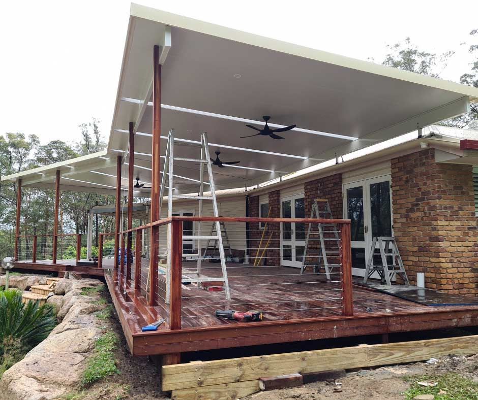A Large Deck Is Being Built On The Side Of A House — Nyblad Construction in Caloundra West, QLD