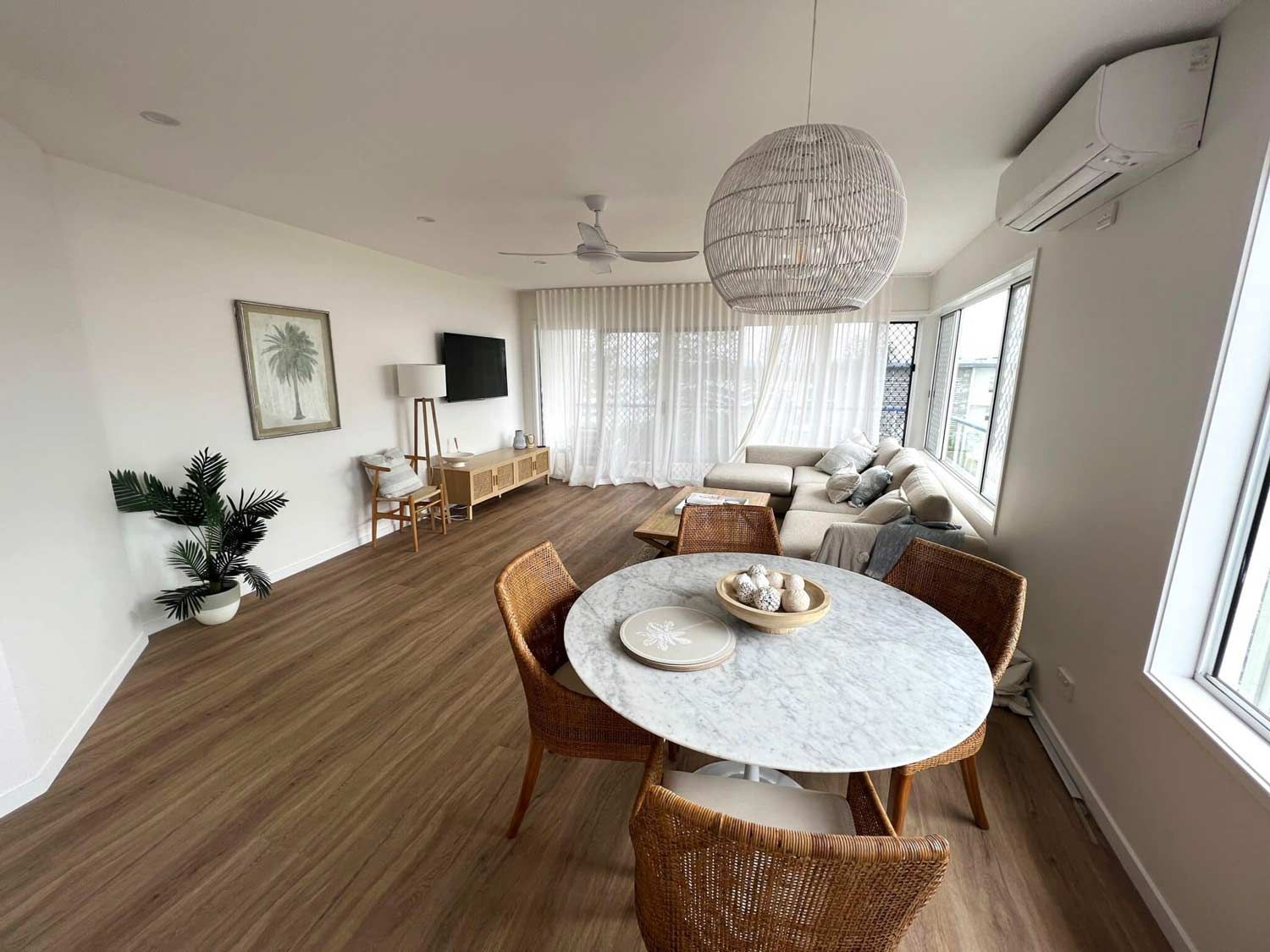 A Living Room With A Round Table And Chairs And A Couch — Nyblad Construction in Caloundra West, QLD