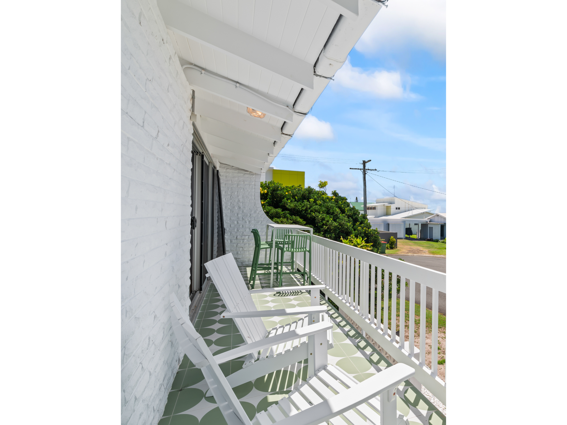 A White Brick House With Chairs On The Deck — Nyblad Construction in Caloundra West, QLD