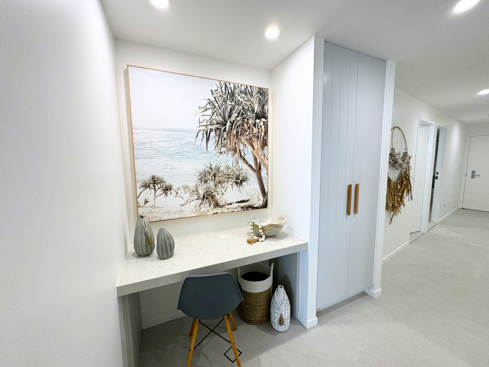 A Desk With A Picture And White Cabinets — Nyblad Construction in Caloundra West, QLD