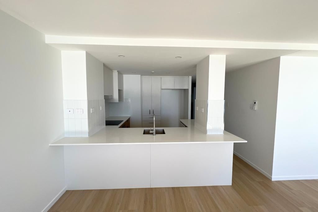Empty Kitchen With White Cabinets — Nyblad Construction in Caloundra West, QLD