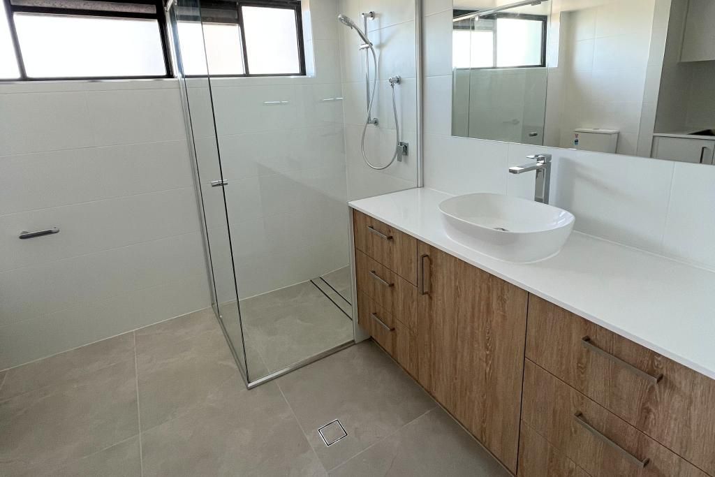 Bathroom With a Sink , Mirror and Walk in Shower — Nyblad Construction in Caloundra West, QLD