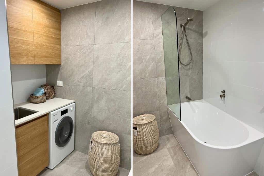 Bathroom With a Washer and Dryer and a Bathtub — Nyblad Construction in Caloundra West, QLD