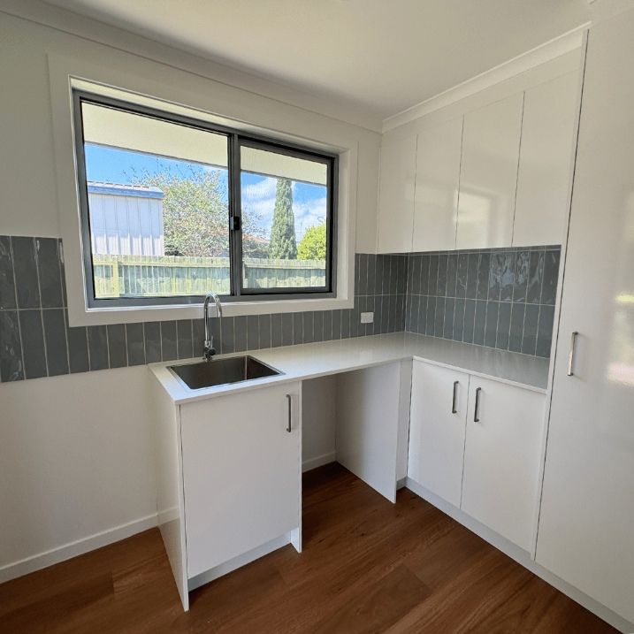 Empty Kitchen With White Cabinets — Nyblad Construction in Caloundra West, QLD