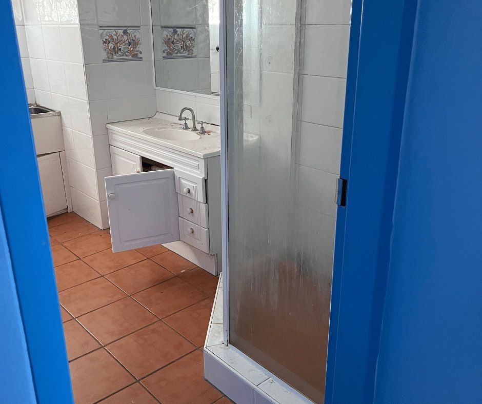 A Bathroom Featuring A Blue-door Shower And A Sink — Nyblad Construction in Caloundra West, QLD