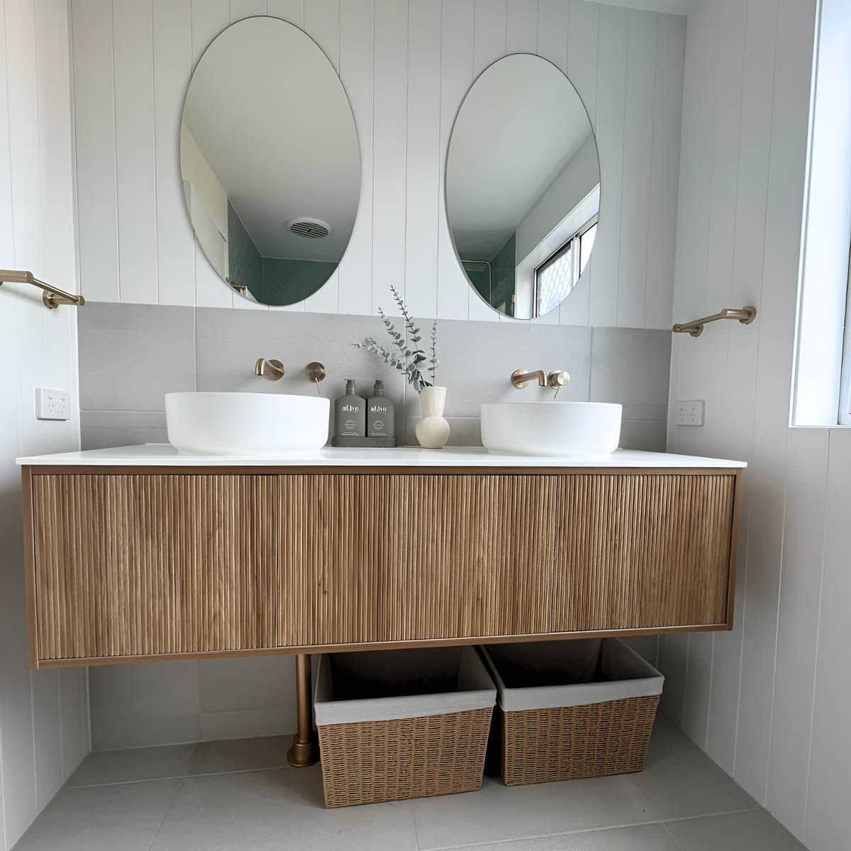 A Minimalist Bathroom With Two Sinks, Two Mirrors, Soap, And Stylish Plants — Nyblad Construction in Caloundra West, QLD